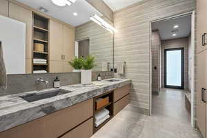 Bathroom with tile walls, vanity, and tile patterned flooring