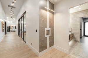 Hallway with light hardwood / wood-style floors