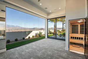 Unfurnished sunroom featuring a water and mountain view