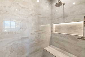 Bathroom featuring a tile shower