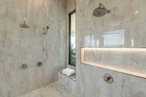 Bathroom featuring plenty of natural light and tiled shower