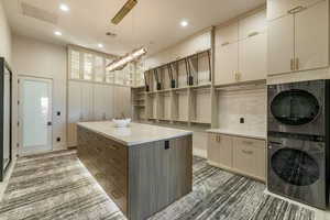 Interior space with stacked washer / dryer and cabinets