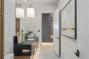 Bathroom featuring sink, toilet, and wood-type flooring