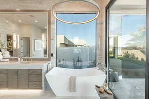 Bathroom featuring a bathing tub and vanity