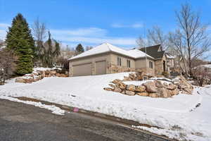 Snow covered property featuring a garage