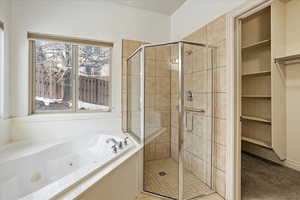 Bathroom featuring shower with separate bathtub