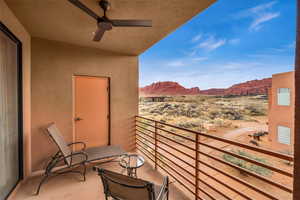 Balcony featuring a mountain view and ceiling fan