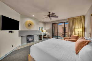 Carpeted bedroom featuring access to exterior and ceiling fan