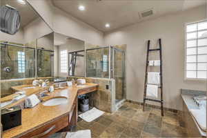 Bathroom featuring plus walk in shower and vanity