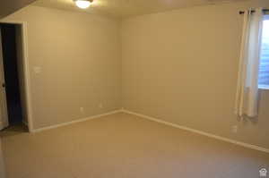 Spare room featuring carpet floors and a textured ceiling