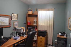 Office space featuring a textured ceiling