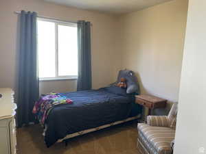 Carpeted bedroom featuring a textured ceiling