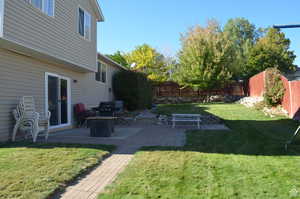 View of yard featuring a patio and a fire pit