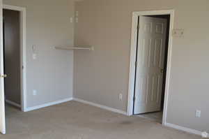 Spare room featuring light colored carpet