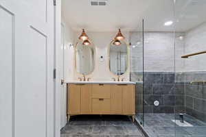 Bathroom with a tile shower and vanity