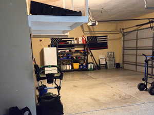 Garage with a garage door opener and Hanging storage,