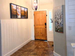 Foyer entrance featuring a notable chandelier.