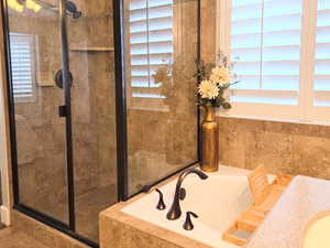 Bathroom featuring separate shower and tub and a textured ceiling