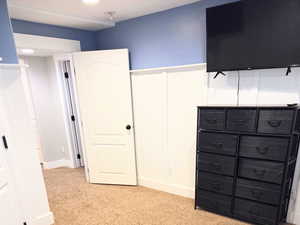 Basement featuring light colored carpet