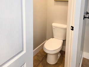 Bathroom featuring tile patterned flooring and toilet