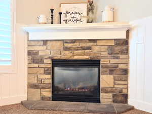 Interior details featuring carpet flooring and a fireplace