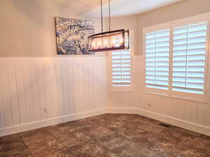 Unfurnished dining area featuring a textured ceiling