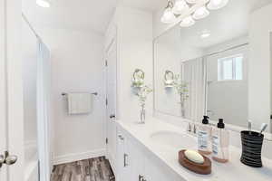 Bathroom featuring hardwood / wood-style flooring and vanity