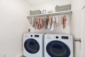 Clothes washing area featuring washing machine and dryer