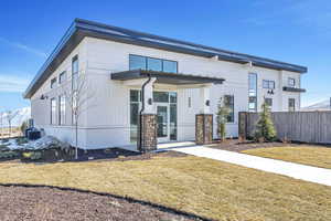 View of front of house with a front yard and cooling unit