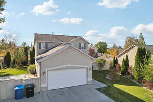 View of property with a front yard and a garage