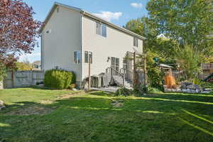 Back of house with a lawn