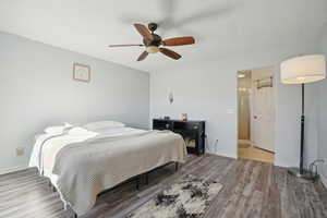 Bedroom with hardwood / wood-style flooring and ceiling fan