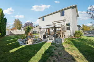 Rear view of property featuring a patio, a yard, and a gazebo