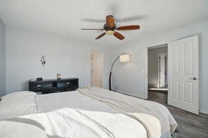 Bedroom featuring ceiling fan and dark hardwood / wood-style flooring