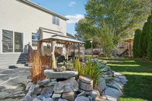 View of yard with a playground and a gazebo