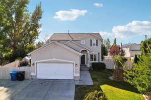 View of front property with a garage and a front lawn