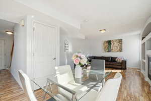 Dining area with light hardwood / wood-style flooring