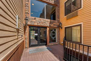 Property entrance with french doors and a wooden deck