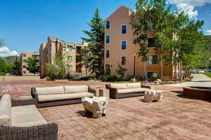 View of community with a patio area and an outdoor hangout area