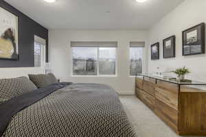 Bedroom featuring light colored carpet