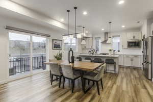 Dining space with light hardwood / wood-style floors