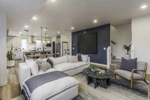 Living room with light wood-type flooring and sink