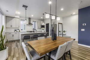 Dining area featuring light wood-type flooring and sink