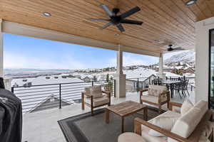 Snow covered patio featuring an outdoor hangout area and ceiling fan