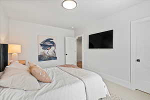 Bedroom featuring carpet and a textured ceiling