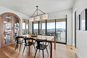 Dining room with ceiling fan, a mountain view, a textured ceiling, and light hardwood / wood-style flooring