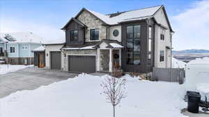 View of front of house with a garage and a mountain view