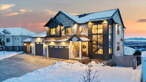 View of front of property with a mountain view and a garage