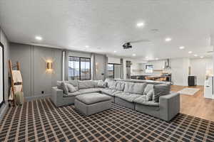 Living room featuring a textured ceiling and hardwood / wood-style floors