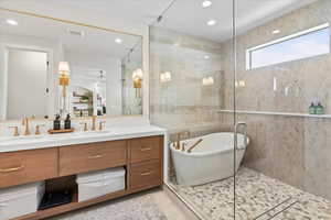 Primary Bathroom with vanity and shower with separate bathtub